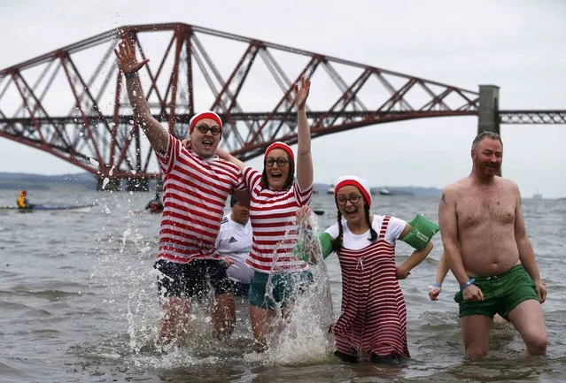 Swimmers participate in the New Year's Day Loony Dook swim at South Queensferry in Scotland, Britain January 1, 2016. (Photo by Russell Cheyne/Reuters)