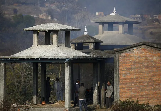 Family members and villagers gather during the cremation of Wilson Dangol, 10, an earthquake victim after he died suffering from pneumonia at Khokana in Lalitpur, Nepal January 4, 2016. (Photo by Navesh Chitrakar/Reuters)
