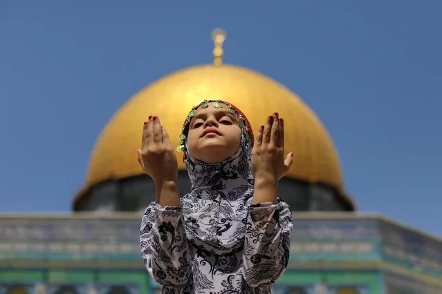 A Palestinian girl prays in front of the Dome of the Rock, in the compound known to Muslims as Noble Sanctuary and to Jews as Temple Mount, in Jerusalem's Old City, on the second Friday of Ramadan in Jerusalem on April 23, 2021. (Photo by Ammar Awad/Reuters)