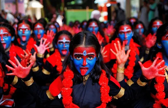 Students with faces painted as Hindu goddess Kali, take part in a cultural event ahead of the Janmashtami festival, or the birth anniversary of Hindu Lord Krishna, inside a college in Mumbai, India on September 4, 2023. (Photo by Francis Mascarenhas/Reuters)