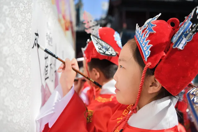 Students take part in the traditional “first writing ceremony” in Taiyuan City, north China's Shanxi Province on September 12, 2023. (Photo by Rex Features/Shutterstock)