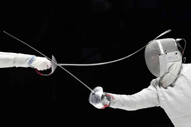 Shen Chenpeng, left, of China competes against Gu Bongil of South Korea during the men's sabre team finals match of the 19th Asian Games in Hangzhou, China, Thursday, September 28, 2023. (Photo by Aaron Favila/AP Photo)
