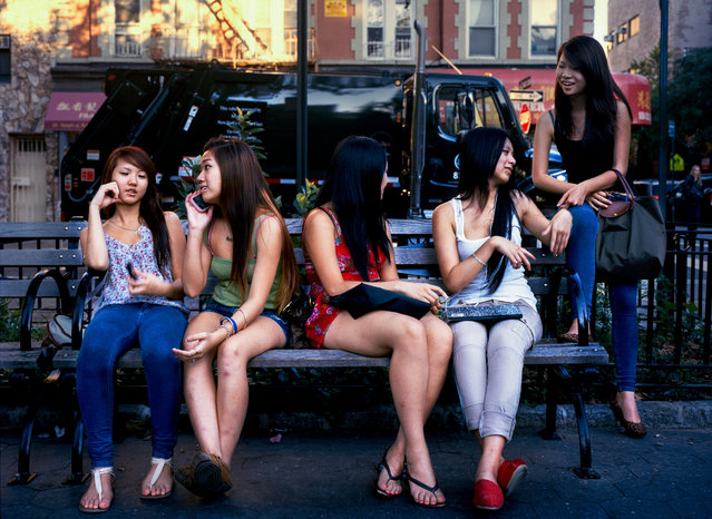 Girls sits on a bench during summer at the Central Park in New York, United States, 2011. (Photo by An Rong Xu)
