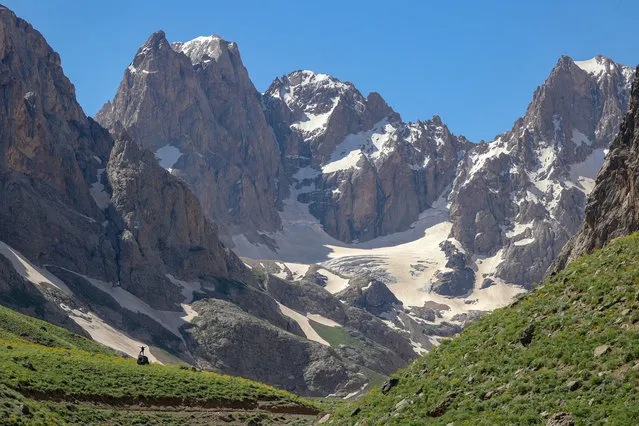 Nature and photography lovers visit Mount Cilo in Turkey's Eastern Anatolian province Hakkari on June 09, 2021. Cilo Mountains located on Ikiyaka mountains declared “National Park” is one of the natural beauty spots for travelers in Hakkari's Yuksekova district. 27,500 hectares of national park area draws attention coexisting four seasons with colorful flowers and snow on top of hills. Uludoruk, the second highest mountain in Turkey, located on Cilo Mountains, is often visited due to its waterfalls, glacial lakes and snow. (Photo by Ozkan Bilgin/Anadolu Agency via Getty Images)