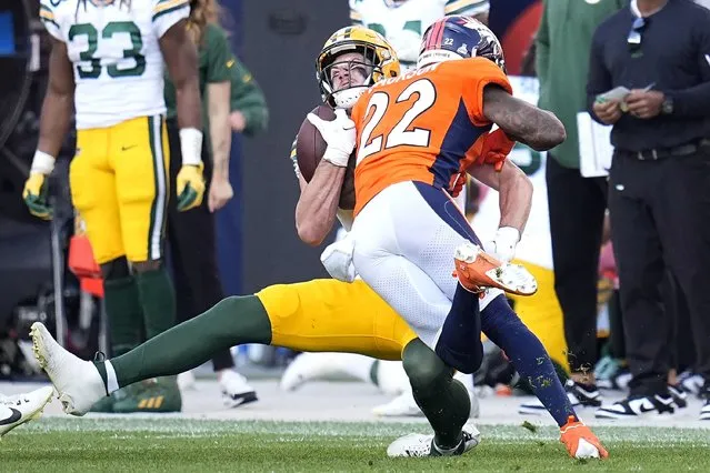 Green Bay Packers tight end Luke Musgrave, rear, is hit by Denver Broncos safety Kareem Jackson (22) during the second half of an NFL football game in Denver, Sunday, October 22, 2023. Jackson was penalized for the hit and disqualified from the game after the play. (Photo by Jack Dempsey/AP Photo)