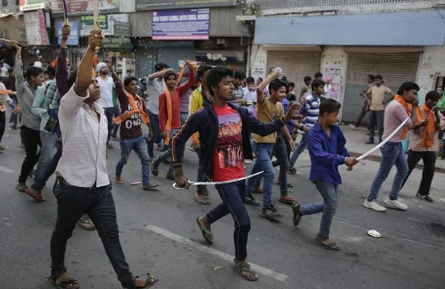 Hindus brandishing swords participate in a religious procession on Ram Navami festival in New Delhi, India, Saturday, March 28, 2015. (Photo by Altaf Qadri/AP Photo)