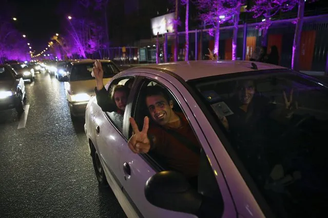 Iranians flash the victory sign from their car while celebrating on a street in northern Tehran, Iran, Thursday, April 2, 2015, after Iran's nuclear agreement with world powers in Lausanne, Switzerland. (Photo by Vahid Salemi/AP Photo)