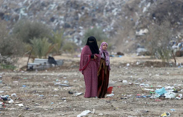 Palestinian women stand outside their dwellings in Khan Younis in the southern Gaza Strip December 19, 2016. (Photo by Ibraheem Abu Mustafa/Reuters)