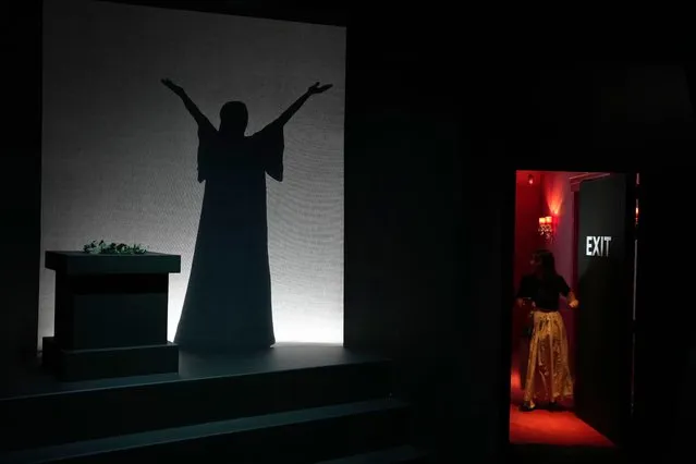 An employe opens a door as the silhouette of Greek Soprano Maria Callas is shown on screen, at the newly established Museum, the first dedicated to the legendary opera star, in Athens, Greece, Wednesday, October 25, 2023. The new museum presents, priceless historical artifacts, including photographs and portraits, rare live recordings, and a unique collection of records and personal items as this year is the 100th anniversary of Maria Callas' birth. (Photo by Thanassis Stavrakis/AP Photo)