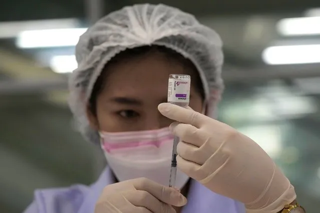 A health worker prepares a shot of the AstraZeneca COVID-19 vaccine for people at the Central Vaccination Center in Bangkok, Thailand, Thursday, July 22, 2021. (Photo by Sakchai Lalit/AP Photo)