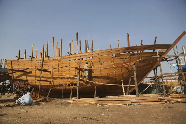 Carpenters work building a fishing boat at a harbor in Karachi, Pakistan, Monday, January 14, 2019. The fishing industry plays a vital role in the economy of Pakistan. (Photo by Fareed Khan/AP Photo)
