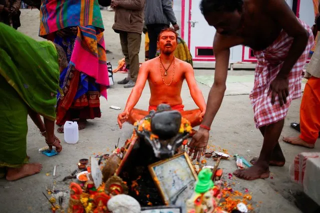 A Hindu devotee prays before taking a holy dip in the waters of the Sarayu river before the inauguration of the Hindu Lord Ram temple in Ayodhya, India on January 22, 2024. (Photo by Adnan Abidi/Reuters)