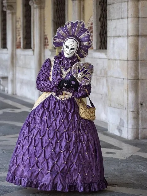 A woman dressed in Carnival Costume poses at the Doge Palace in Venice. (Photo by Marco Secchi/Getty Images)