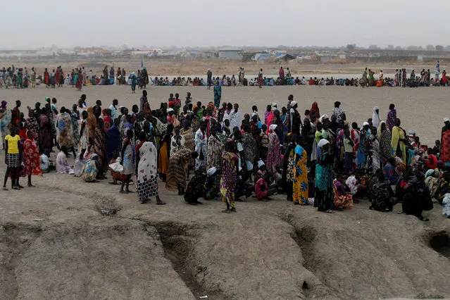 People wait to receive food inside the United Nations Mission in South Sudan (UNMISS) Protection of Civilians site (PoC), near Bentiu, northern South Sudan, February 10, 2017. (Photo by Siegfried Modola/Reuters)