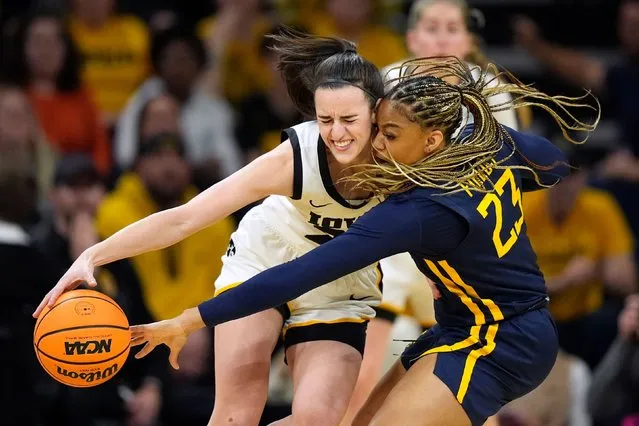West Virginia guard Lauren Fields (23) tries to steal the ball from Iowa guard Caitlin Clark in the first half of a second-round college basketball game in the NCAA Tournament, Monday, March 25, 2024, in Iowa City, Iowa. (Photo by Charlie Neibergall/AP Photo)