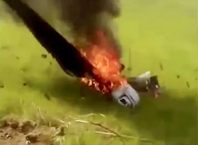 In this frame grab made from a video provided by the Karabakh Forces, Monday, April 4, 2016, a drone burns after it was downed by Armenian forces in Nagorno-Karabakh, Azerbaijan. Azerbaijan and separatist forces agreed on a cease-fire starting noon local time Tuesday, following three days of heavy fighting in the disputed region, the Azeri defense ministry announced. (Photo by Karabakh Forces Photo via AP Photo)