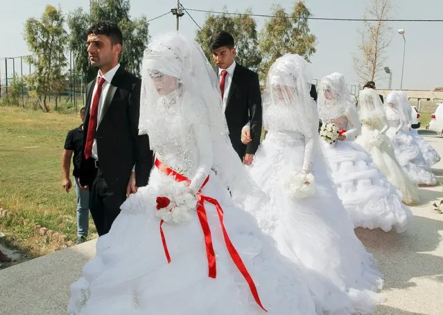 Turkmen brides and grooms, who are displaced and have fled the violence in the province of Nineveh, arrive to attend a mass wedding ceremony in Kirkuk, Iraq, April 7, 2016. (Photo by Ako Rasheed/Reuters)