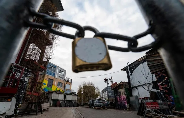 A locked gate blocks access to the Holzmarkt 25 bar area on the banks of the river Spree, close to the Kater Blau club on December 27, 2021. In response to the growing occurence of the Covid-19 Omicron variant in Germany, the federal government has put a lid on New Year celebrations, with discotheques slated to close from December 28, 2021 onwards. (Photo by John MacDougall/AFP Photo)