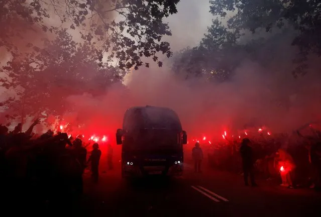 Fans with flares as the FC Barcelona team bus arrives outside the stadium before their Champions League match with Paris St Germain in Barcelona, Spain on April 16, 2024. (Photo by Albert Gea/Reuters)