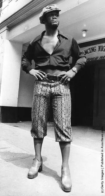 1973: Joe Frazier, World Champion Heavyweight boxer models clothing at Leicester Square Empire Ballroom