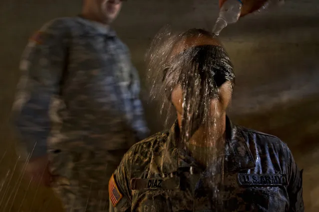 U.S. Army Sgt. Fernando Diaz, a combat medic assigned to 568th Medical Company (Ground Ambulance), Camp Humphreys, Republic of Korea, is blind folded and has ice cold water dumped over his head during a mock interrogation by opposition forces prior to a 100 question written test on medical knowledge as part of the 2012 Pacific Regional Medical Command Best Medic Competition August 30, 2012, at Schofield Barracks, in Wahiawa, Hawaii. (Photo by Tech Sgt Michael R. Holzworth/U.S. Air Force)