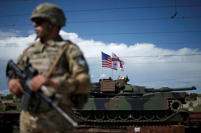 A Georgian serviceman stands in front of U.S. M1A2 “Abrams” tank upon the joint U.S.-Georgian exercise Noble Partner 2016 in Vaziani, Georgia, May 5, 2016. (Photo by David Mdzinarishvili/Reuters)