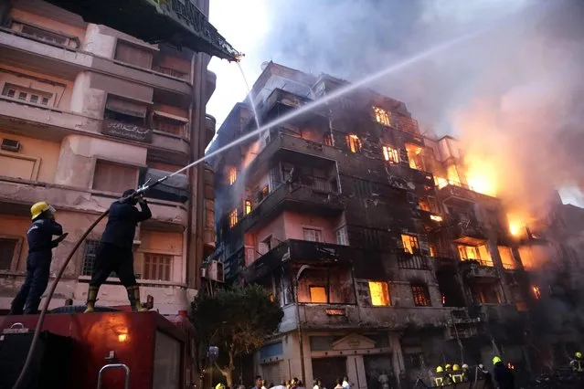 Egyptian firefighters extinguish fire at the popular market area of al-Atabaa in downtown Cairo, on May 9, 2016. At least 50 people including firefighters suffered minor injuries when a fire spread quickly through a commercial area in downtown Cairo, Egyptian officials said. The fire erupted overnight in a small hotel in the Al-Mosky neighbourhood, not far from the Al-Azhar mosque, and moved rapidly to four nearby buildings, police told AFP. (Photo by Ahmed Abd El-Gawad/AFP Photo)