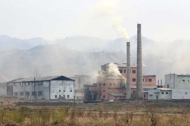 Smoke rises from buildings in an industrial zone near the banks of the Yalu River in Sinuiju, North Korea, which borders Dandong in China's Liaoning province, April 16, 2017. (Photo by Aly Song/Reuters)
