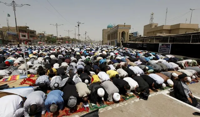Shi'ite Muslims attend Friday prayers in Baghdad's Sadr City July 10, 2015. (Photo by Ahmed Saad/Reuters)