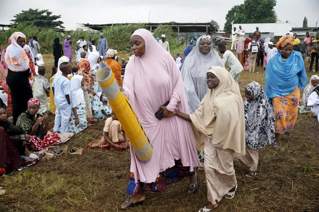 Muslims arrive for Eid-al-Fitr prayer, marking the end of the holy month of Ramadan, in an open field in Lagos July 17, 2015. (Photo by Akintunde Akinleye/Reuters)