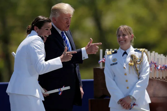 U.S. President Donald Trump poses for a photograph with Ensign Erin Reynolds (L) after presenting her commission at the U.S. Coast Guard Academy commencement in New London, Connecticut, U.S., May 17, 2017. (Photo by Brian Snyder/Reuters)