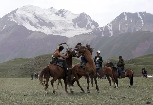 Participants wrestle while riding horses during the Kyrgyz national horse games and festival near the Tulpar-Kul lake in the Chon Alai mountain range, some 3500 metres (11483 feet) above sea level, in the Osh region of Kyrgyzstan, July 25, 2015. (Photo by Vladimir Pirogov/Reuters)
