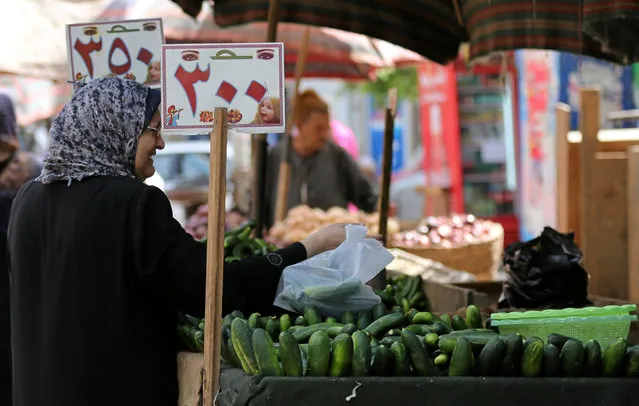 An Egyptian woman shops at a vegetable market in Cairo, Egypt May 10, 2016. (Photo by Mohamed Abd El Ghany/Reuters)