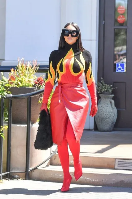 Kim Kardashian makes a serious fashion statement as she steps out with her sisters Kourtney and Khloe for lunch in Calabasas on April 13, 2022. The sisters were seen out filming their new Hulu show and Kim's outfit was absolute Fire. (Photo by @CelebCandidly/Backgrid USA)