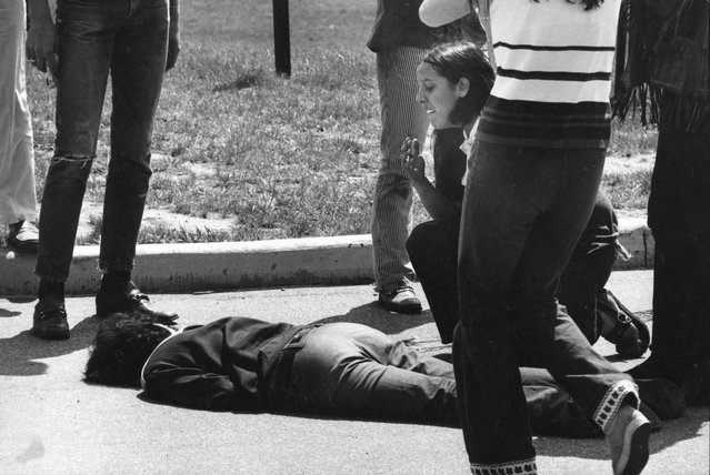 Teenager Mary Ann Vecchio kneels over the body of Kent State University student Jeffrey Miller (1950 - 1970) who had been shot during an anti-war demonstration on the university campus, Kent, Ohio, May 4, 1970. The protests, initially over the US invasion of Cambodia, resulted in the deaths of four protesters, including Miller, and the injuries of nine others after the National Guard opened fire on students. (Photo by Howard Ruffner/Getty Images)