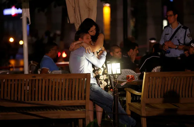 People hug each other following a shooting attack that took place in the center of Tel Aviv June 8, 2016. (Photo by Baz Ratner/Reuters)