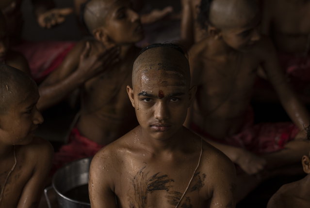 A Nepalese student from a Hindu school attends a mass worship ceremony to mark the Janai Purnima Festival celebrations on the premises of Pashupatinath temple in Kathmandu, Nepal, 19 August 2024. (Photo by Narendra Shrestha/EPA)