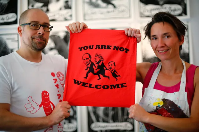 Nele Maack and Rolf Schade present their print design in their shop “druck dealer”, close to Hamburg Messe, to protest against the upcoming G20 summit in Hamburg, Germany July 3, 2017. (Photo by Hannibal Hanschke/Reuters)