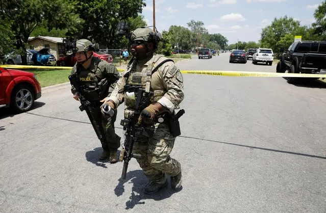 Law enforcement personnel run away from the scene of a suspected shooting near Robb Elementary School in Uvalde, Texas, U.S. May 24, 2022. (Photo by Marco Bello/Reuters)