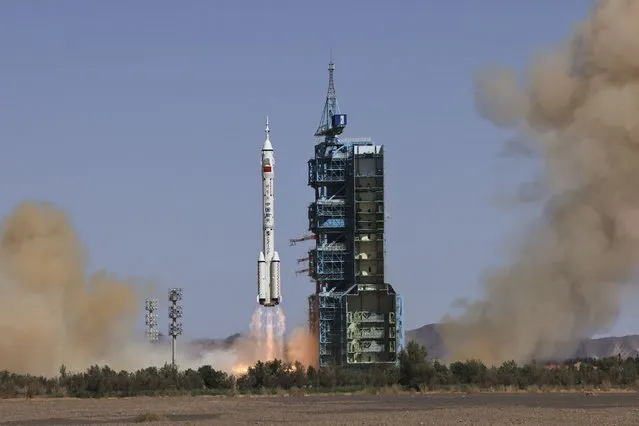 In this photo released by Xinhua News Agency, the Long March-2F carrier rocket carrying China's Shenzhou 14 spacecraft blasts off from the launch pad at the Jiuquan Satellite Launch Center in Jiuquan, northwest China's Gansu Province, Sunday, June 5, 2022. China on Sunday launched the new three-person mission to complete work on its permanent orbiting space station. (Photo by Li Gang/Xinhua via AP Photo)