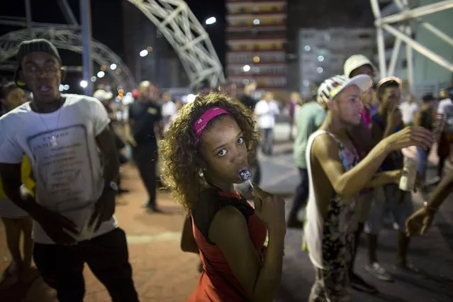 Yumila Figueroa, 25, (C), looks to the camera during a birthday concert in honor of Cuba's former President Fidel Castro at the Anti-Imperialist Stage in Havana August 12, 2015. (Photo by Alexandre Meneghini/Reuters)