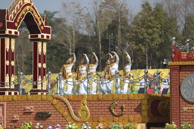 A traditional artist group performs on a decorated truck during a ceremony to mark Myanmar's 75th anniversary Union Day in Naypyitaw, Myanmar, Saturday, February 12, 2022. (Photo by AP Photo/Stringer)