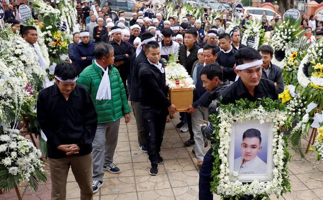 Relatives of John Hoang Van Tiep, a victim who was found dead in the back of a British truck last month, carry his coffin to a church for his funeral in Nghe An province, Vietnam on November 28, 2019. (Photo by Reuters/Kham)