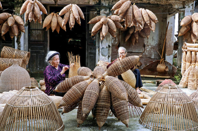 Women make conical fishing traps from bamboo in the traditional craft in Thu Sy trade village, Hung Yen, Vietnam in the last decade of September 2024. The traps are cheap, durable, environmentally friendly and easy to use. (Photo by Sabina Akter/Solent News)