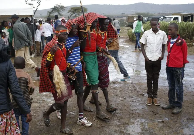 Tribesmen walk in the rain during the Maralal Camel Derby, Kenya, August 15, 2015. (Photo by Goran Tomasevic/Reuters)