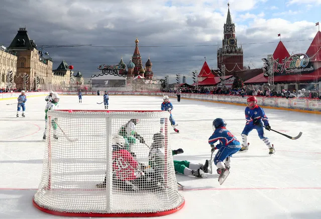 Participants in a bandy match between Team Irkutsk Region and the Zvezda Urala (A Star of the Urals) team at the GUM ice skating rink in Moscow's Red Square on February 19, 2020 held as part of the 10th Patriarch Kirill of Moscow and all Russia Bandy Tournament for children. (Photo by Alexander Shcherbak/TASS)