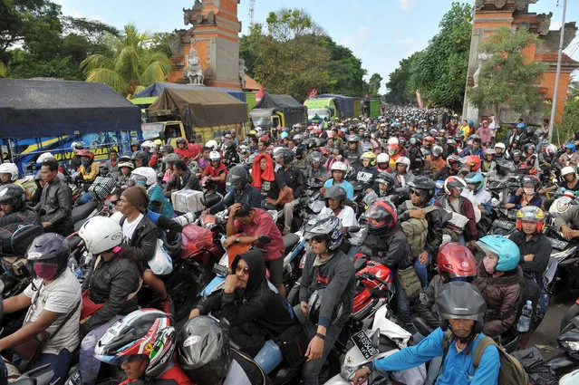 Thousands of travellers heading to their hometowns to celebrate Eid al-Fitr, the Muslim holiday to mark the end of Ramadan, wait in a traffic jam to board a ferry at the entrance to Gilimanuk port on Bali, Indonesia July 3, 2016 in this photo taken by Antara Foto. (Photo by Nyoman Budhiana/Reuters/Antara Foto)