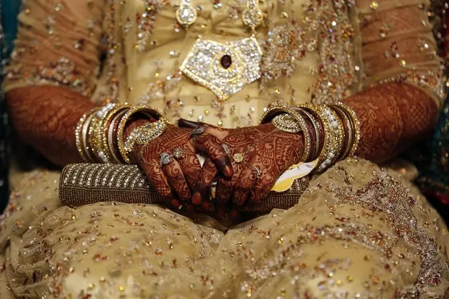 In this May 11, 2014 file photo, an Indian Muslim bride sits during a mass marriage where thirty-five couple got married in Mumbai, India. India's Supreme Court said Tuesday, August 22, 2017 that the Muslim practice that allows men to instantly divorce their wives is unconstitutional and requested the government legislate an end to the practice. (Photo by Rajanish Kakade/AP Photo)