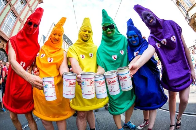 People dressed up as coloured condoms collect donations for the Frankfurt AIDS aid during a rally on the occasion of Christopher Street Day at the Roemerberg in Frankfurt on the Main, Germany, 16 July 2016. According to the police, around 1500 people marched through the centre of Frankfurt under the Motto “Love against the Rightwing”. (Photo by Frank Rumpenhorst/AP Images/DPA)