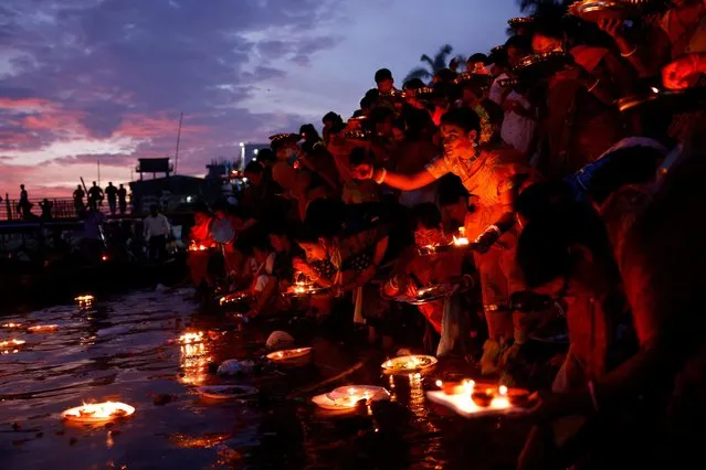 Hindu devotees release oil lamps to the Buriganga River as they observe Bipottarini Puja in Dhaka, Bangladesh, July 5, 2022. (Photo by Mohammad Ponir Hossain/Reuters)